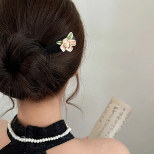 Elegant vintage hair stick with beige magnolia flower and green leaves for updos