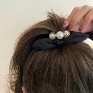 French vintage black bow hair tie with large white pearls for elegant ponytail hairstyles