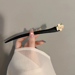 Vintage wooden hair stick with beige camellia flower and green leaves for elegant buns