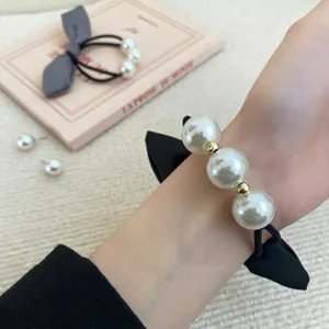 French vintage pearl bow hair tie featuring black ribbon and large white beads