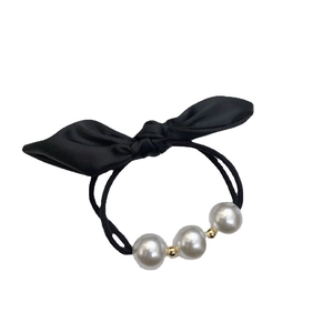 French vintage black bow hair tie with elegant pearls and golden beads on white background