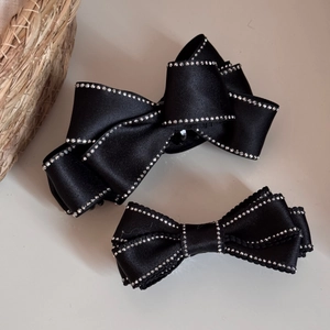 Elegant black satin bow hair clips set with sparkling rhinestones and non-slip grip design