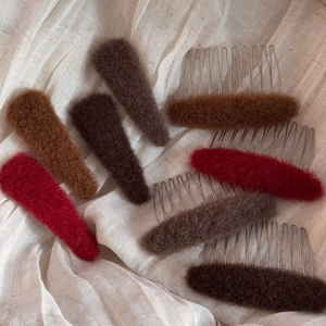Elegant oval plush hair side combs in autumn warm tones on a minimalist linen background