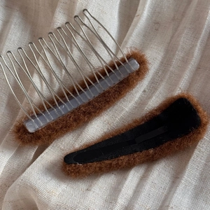 Detail of plush oval hair comb and clip set with soft brown faux fur texture