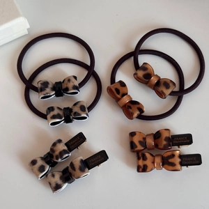 Close-up of leopard print hair bows and acetate clips with France Handmade engraving