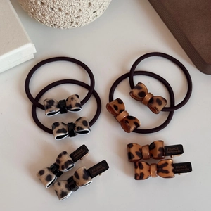 Detail of leopard print bow hair clips and elastic ties with France Handmade engraving