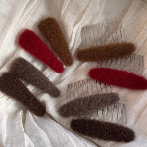 Detail of plush velvet hair clips and metal combs in warm autumn brown and red colors
