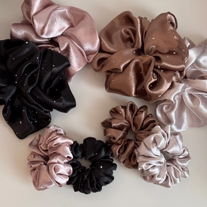 Detail of satin scrunchies with rhinestones in pink, brown, grey and black colors