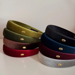 Padded velvet headband collection in various colors with handmade gold metal tag