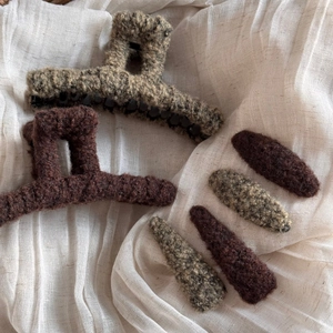 Close-up of soft faux shearling hair claws and clips in chocolate brown and earthy tones
