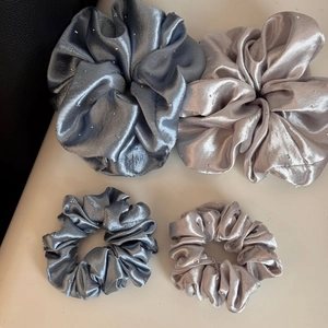 Macro view of satin scrunchies with rhinestones in grey and champagne colors