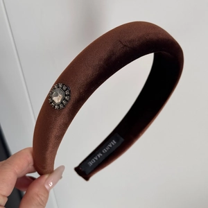 Close-up of brown velvet braided headband featuring a vintage octagonal gemstone detail