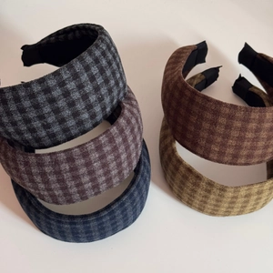 Detailed close-up of retro British plaid headbands in five classic autumn fabric colors