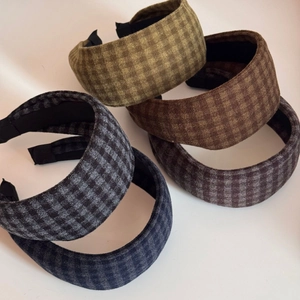 Close-up of five British vintage plaid headbands in various colors on flat background