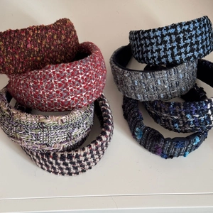 Close-up of assorted tweed sponge headbands in various colors and textured fabrics