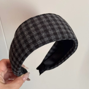 Close-up of British style grey plaid velvet headband with soft inner lining texture