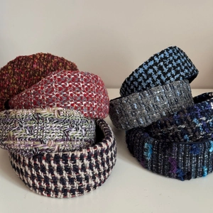 Assorted thick tweed wide headbands in various vintage patterns for a high skull top look