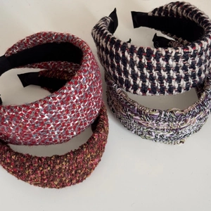 Detail showing four assorted tweed knit headbands with thick textures and varied patterns