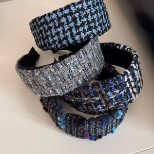 Close-up of assorted tweed headbands showing thick knit textures and sequins