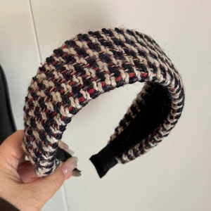 Detail of multi-color thick knit tweed headband with textured weave and soft lining