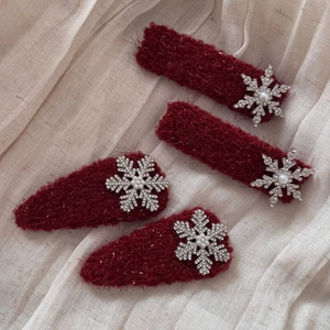 Elegant red velvet snowflake hair clips set with pearls and rhinestones for winter styling