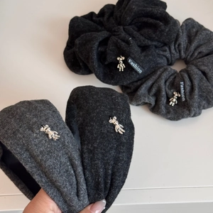 Close-up of winter velvet headbands and scrunchies with silver metal bear charms