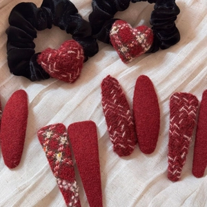 Winter red plaid hair clips set and heart velvet hair ties on white fabric