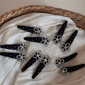 Set of 9 black polka dot hair clips with silver floral accents and sparkling rhinestones