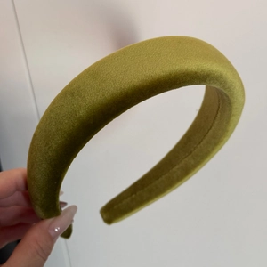 Detailed shot of olive green velvet padded headband showing thick sponge and soft texture