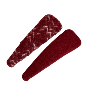 Set of two red knitted hair clips featuring herringbone pattern on white background