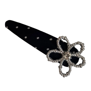 Black polka dot fabric hair clip with a silver flower and sparkling center crystal