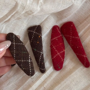 Detailed macro view of felt hair clips with retro white diamond stitching pattern