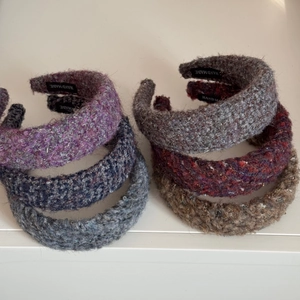 Detail of multi-colored handmade knit headbands with refined texture and hand made label