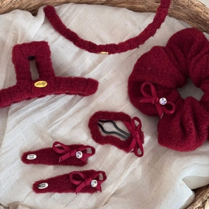 5-piece burgundy plush hair accessory set with Lucky gold metal label in woven basket