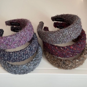 Detail showing various tweed texture headbands with silver thread and handmade labels