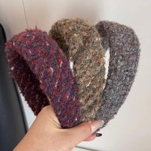 Three-piece set of wide plush bouclé knit headbands in dark red, light brown, and grey blue