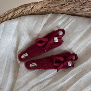 Detailed view of handmade burgundy plush hair clips with velvet bows and sparkling crystals