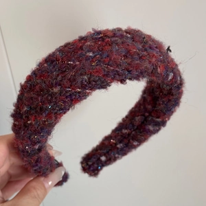 Detail of colorful plush wide headband with woven metallic threads and soft texture