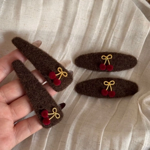 Set of 4 winter cherry bow hair clips in brown felt with red pom-poms and gold cords