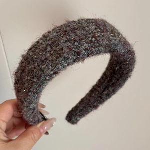Detailed texture of thick plush knit headband with grey-purple shimmering fibers