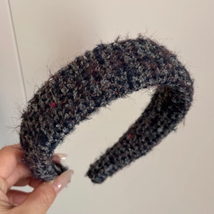 Detail of grey tweed plush headband with thick wool texture and subtle shimmer