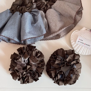 Brown and blue striped fabric scrunchie set with pleated layers and elegant ruffled edges