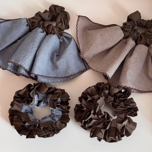 Set of four striped fabric scrunchies in brown and blue with ruffle hem detail