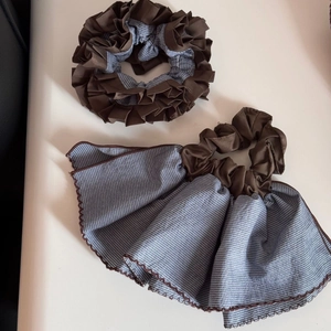 Detail of coffee brown and blue striped oversized scrunchies with wavy edges