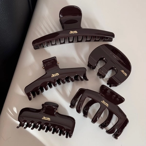 Detail view of five brown large hair claws with golden Barrette La France inscription