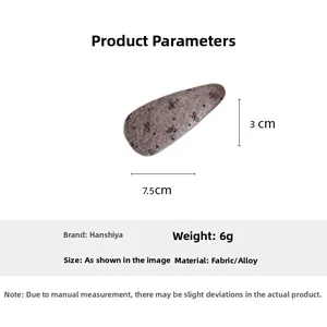 Detailed view of grey bow fabric hair clip with dimensions and material specifications