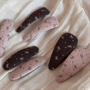 Elegant wool felt bow hair clips in brown and dusty pink with white polka dot embroidery