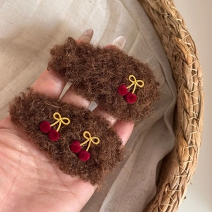 Plush brown hair clips with gold bow and red cherry pom-pom details for autumn