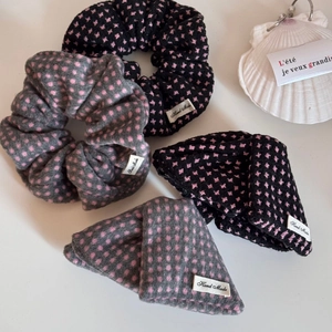 Detail of French style polka dot hair scrunchies with handmade labels on white background