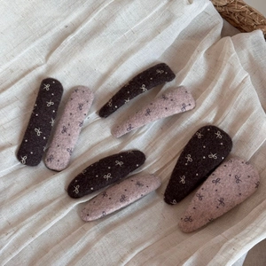 Detailed set of eight wool felt bow hair clips in dark brown and soft pink colors
